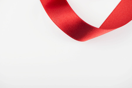 Red fabric ribbon on white background. Abstract. Copy space.の写真素材