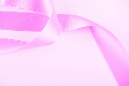 Pink ribbon on white background. Horizontal shoot. Isolated. Copy space.の写真素材