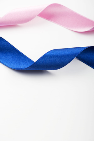 Abstract background of pink and blue ribbons on white background. Copy space. Vertical shoot. の写真素材