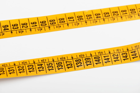 Yellow tape measure on white background. Isolated. Horizontal shoot. の写真素材