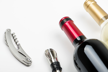Top view of corkscrew on white background next to several corks. Horizontal studio shot. Isolated.の写真素材