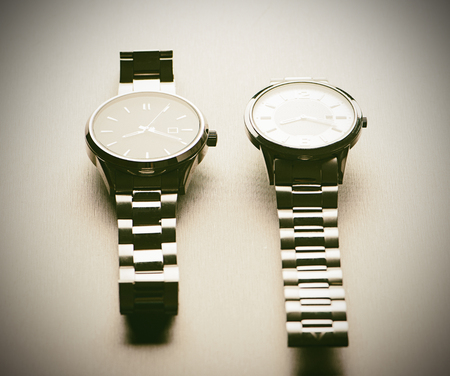 Two metallic wristwatches.