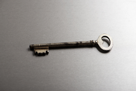 Old key on gray background. Horizontal studio shotの写真素材