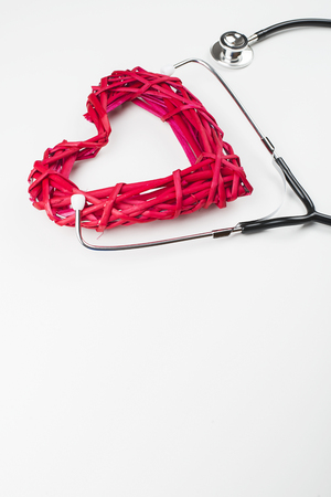 Close-up of creative composition made with big mockup heart and stethoscope on white background. Copy space.の写真素材