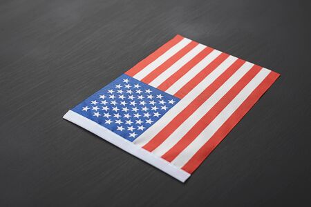 Studio shot of small bright USA flag on black background. Copy space.