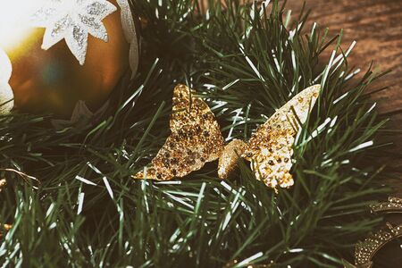Christmas decoration with ball and golden butterfly on christmas tree.の写真素材