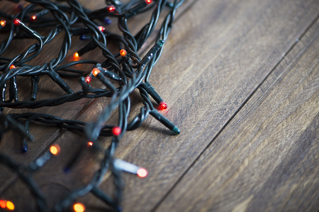 Christmas lights on wooden table.の写真素材