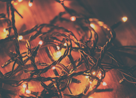 Christmas lights on wooden table.の写真素材
