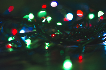 Christmas lights on wooden table.の写真素材