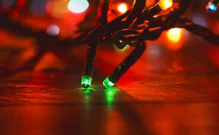 Christmas lights on wooden table.の写真素材