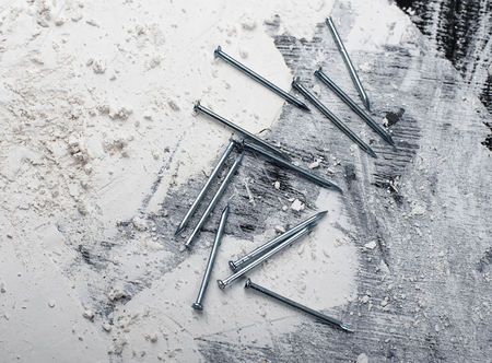 Nails used for construction on wooden base.