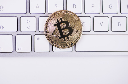 Bitcoin coin on computer keyboard. Cryptocurrencyの写真素材