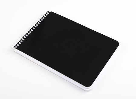 Notebook with black cover on white background. Isolated.の写真素材