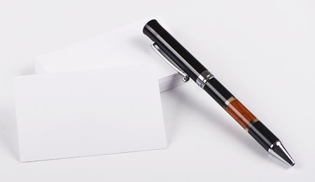 Business cards next to black pen on white background. Isolated. Mockup.の写真素材