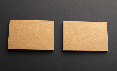 Brown business cards on black background. Mockup.の写真素材