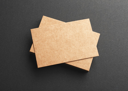 Brown business cards on black background. Mockup.の写真素材