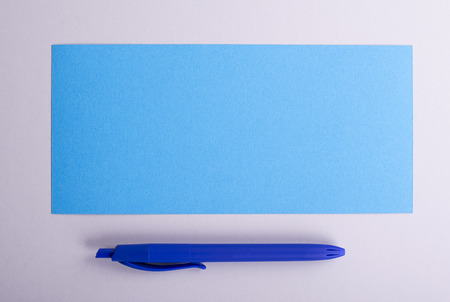 Rectangular card and blue pen. Copy space. Mockup.の写真素材