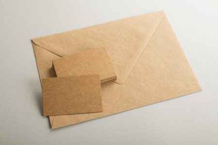 Top view of business cards and envelope of brown color. Copy space. Mockup.の写真素材
