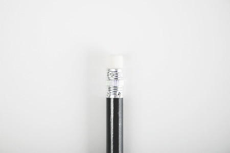 Black pencil with eraser on white background. Isolated. Stationery.の写真素材