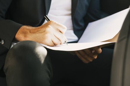 Close-up of hand with pen signing a document. Businessman.の写真素材