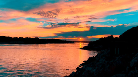 A Beautiful and Stunning Sunset Over Calm and Tranquil Waters Creates a Unique Atmosphereの写真素材