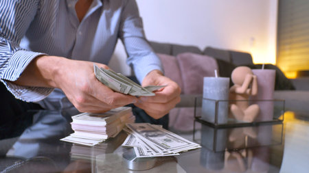 Counting Cash in a Contemporary Living Room Setting with a Stylish and Modern Ambienceの写真素材