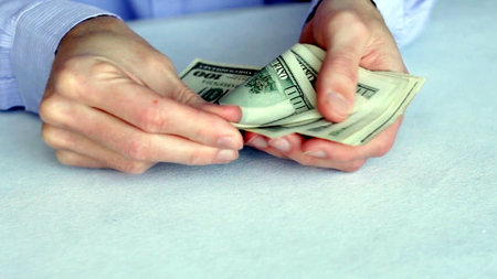 Counting Cash Multiple Hands Handling Dollar Bills During a Financial Transaction Processの写真素材