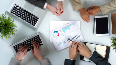 Effective Collaboration in Business Strategy Using Laptops and Informative Charts and Graphsの写真素材