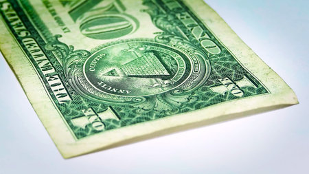 Close-up macro of the Great Seal pyramid and Eye on a U.S. one-dollar bill. Crisp green engraving texture on white background, ideal for finance, banking, cash, savings, inflation, investment, and economic themes.の写真素材