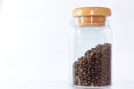 A Roasted Coffee Beans in Glass Jar On white Backgroundの写真素材