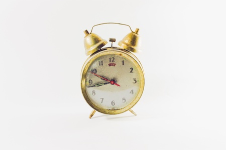 A real old alarm clock isolated on whiteの写真素材