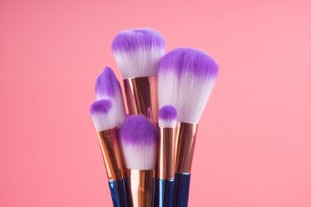 makeup brush set isolated on red pink pastel backgroundの写真素材
