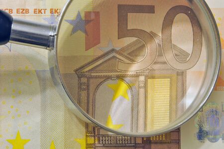 euro currency enlarged with a magnifying glass, euro in Europeの写真素材