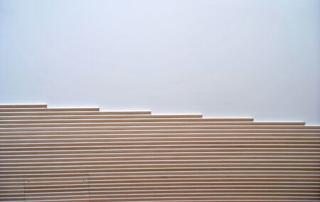 white wall with strips of wood as a modern interior decorationの写真素材