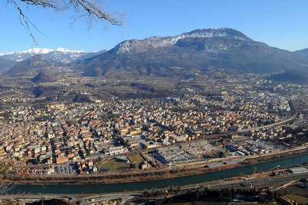 Trento city surrounded by mountains and forestsの写真素材