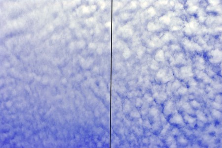 high voltage line and wires with blue sky with white clouds background