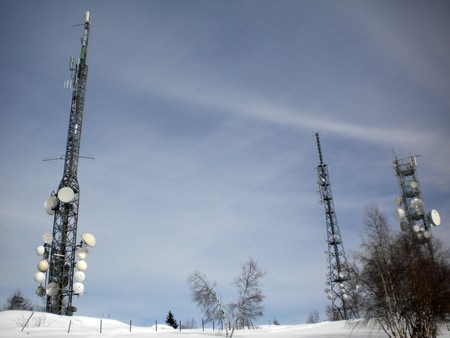 winter landscape with snow and pine trees ground antennas for data transmission and mobile TV