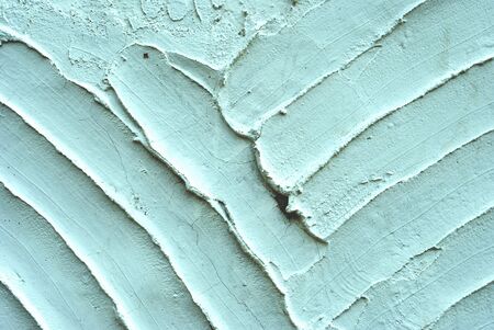 texture with white cement and plaster bas relief lines and spatulaの写真素材