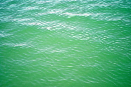 small tidal wave slamming on a sandy beachの写真素材