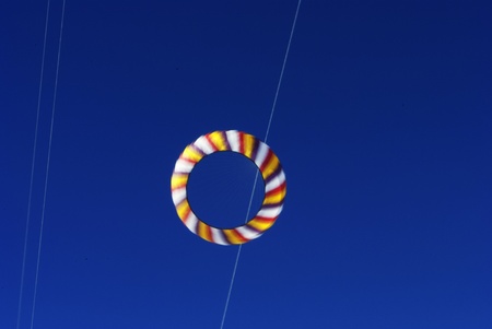 colorful kites flying in the blue skyの写真素材