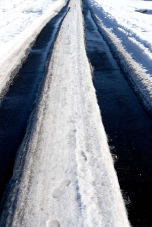paved road in winter with snowの写真素材