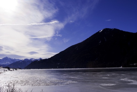 Alpine Lake with snow, ice and water の写真素材