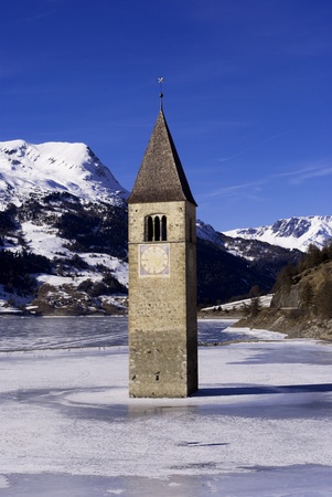alpine lake with a bell tower in the ice, Reschenseeの写真素材