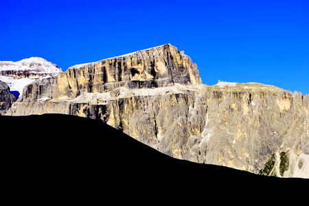 mountains of the Alps, in the spring with green fields and blue skyの写真素材