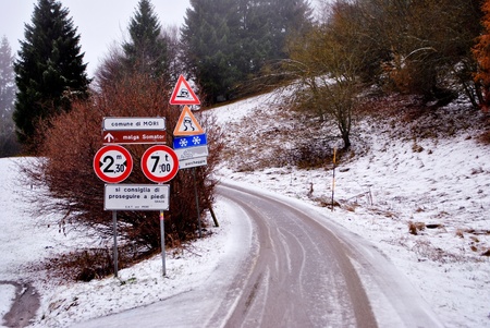 paved road in the mountains with a light layer of snowの写真素材