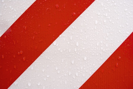 red and white stripes, with drops of waterの写真素材