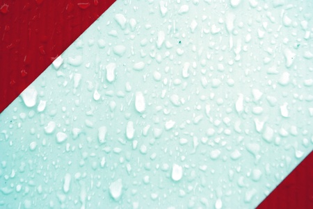 red and white stripes, with drops of waterの写真素材
