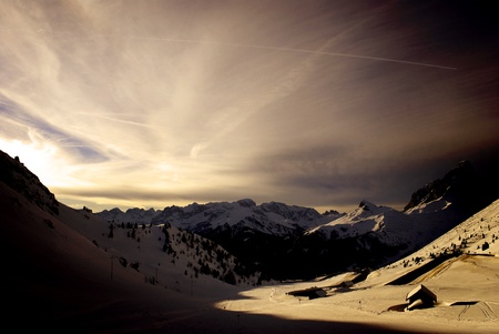 winter landscape with snow capped mountains and blue skyの写真素材