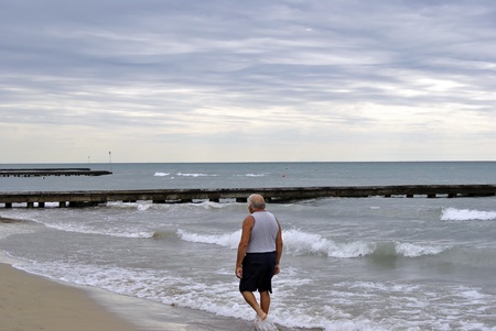 Happy senior take a stroll on a beautiful beach. のeditorial素材