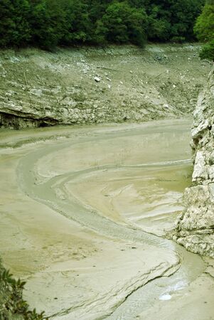 Exposed lake bed in the high country of Italy after a dry summer period